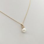 Sárga arany nyaklánc gyöngy medállal