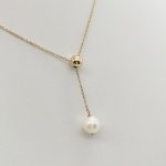 Sárga arany nyaklánc gyöngy medállal