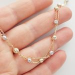 Sárga arany dupla soros nyaklánc sárga-fehér metszett bogyókkal