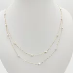 Sárga arany nyaklánc sárga-fehér orsókkal