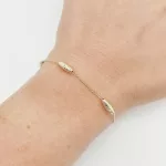 Sárga arany orsó mintás karlánc